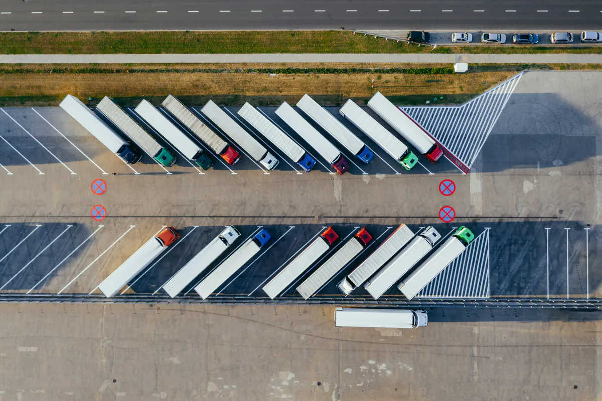 Aerial view of rows of semi-trailers parked at a freight depot in Poland.
